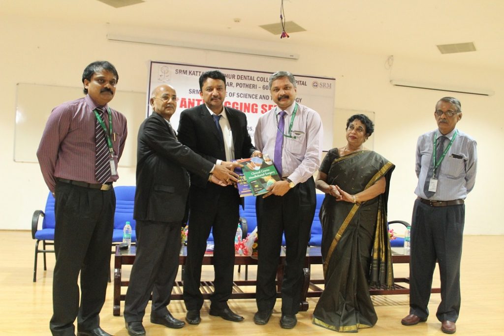 Dr Balaji Presenting The Books Clinical Cranio-Maxillofacial Surgery And Textbook Of Oral And Maxillofacial Surgery Authored By Him To Dr. N Vivek