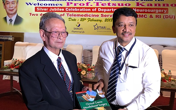 Dr SM Balaji presenting his textbook “Clinical Cranio-Maxillofacial Surgery" to Prof Tetsuo Kanno