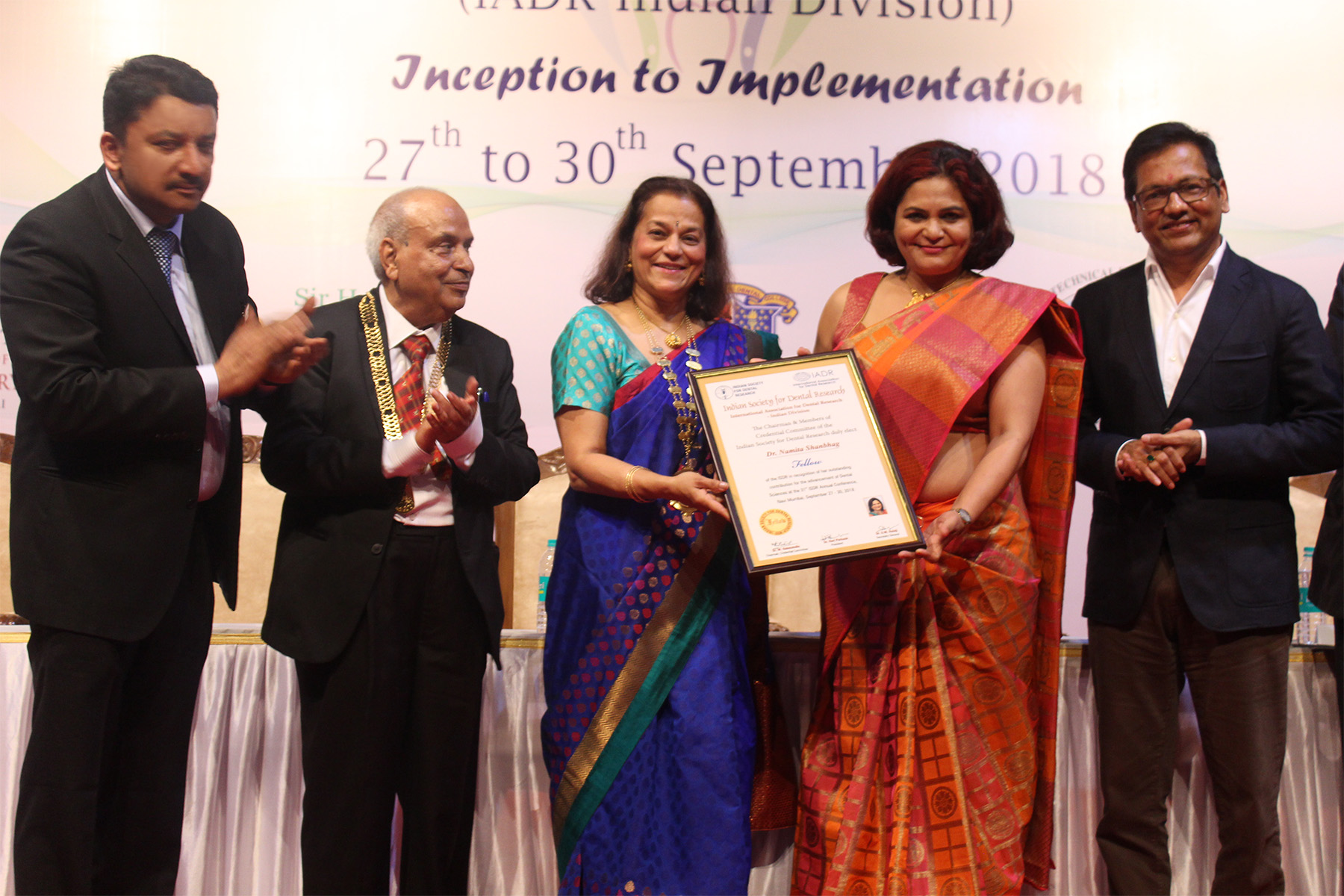 31st Indian Society for Dental Research - International Association for Dental Research Annual Conference, Mumbai 11 Prof Rene D’souza Handing Over The Isdr Fellowship Award To Dr Namita Shanbhag. Also Seen Are Dr Vijay Patil, Dr Sm Balaji And Dr Hari Parkash