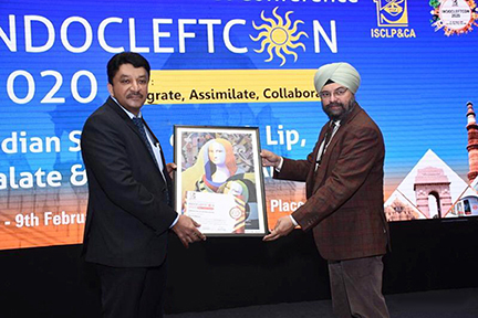 Dr SM Balaji receiving a certificate of appreciation and memento at the Indian Society of Cleft Lip, Palate & Craniofacial Anomalies conference